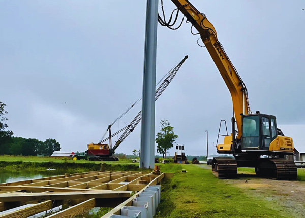 excavator installing sheet pilings